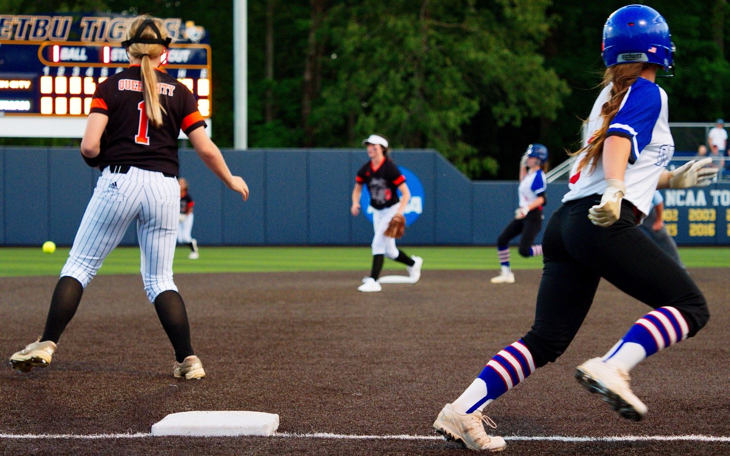 Addie Marcee rounds third base as Peytron Kruckner nears second. Both runners would score on the play, the Lady Bulldogs only runs Wednesday. [catch more of Quitman]